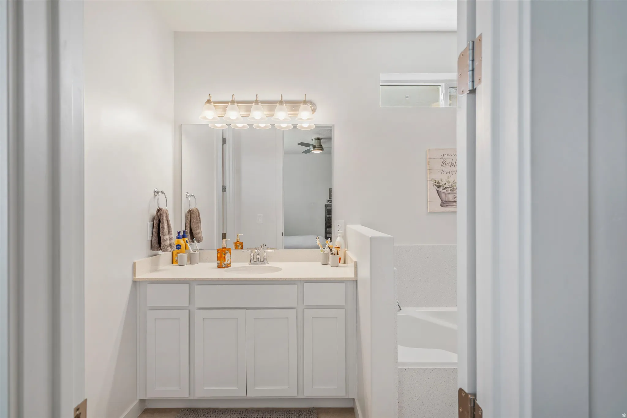 Full bathroom with vanity, a bath, and ensuite bath