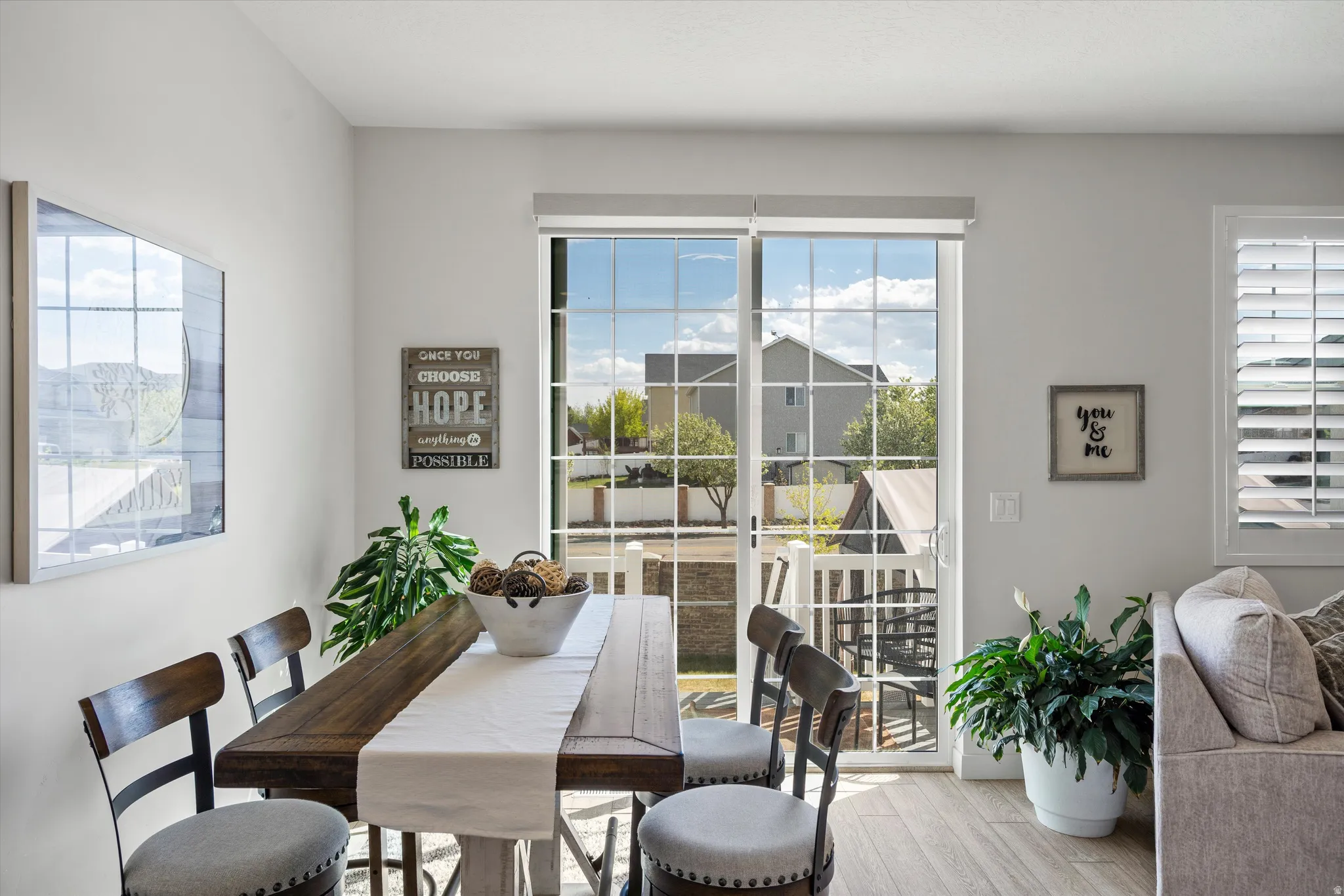Dining space with wood finished floors and plenty of natural light