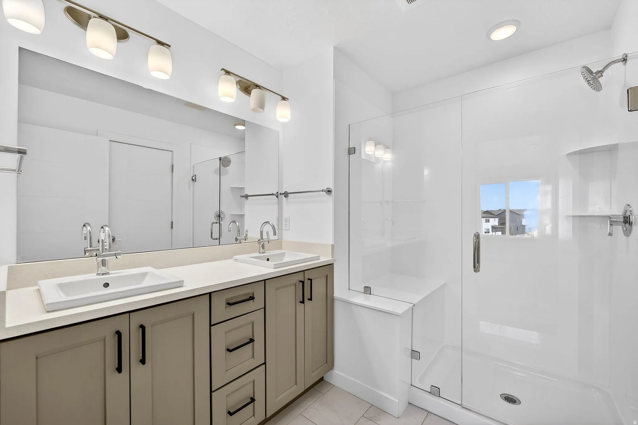 Full bath featuring double vanity and a shower stall