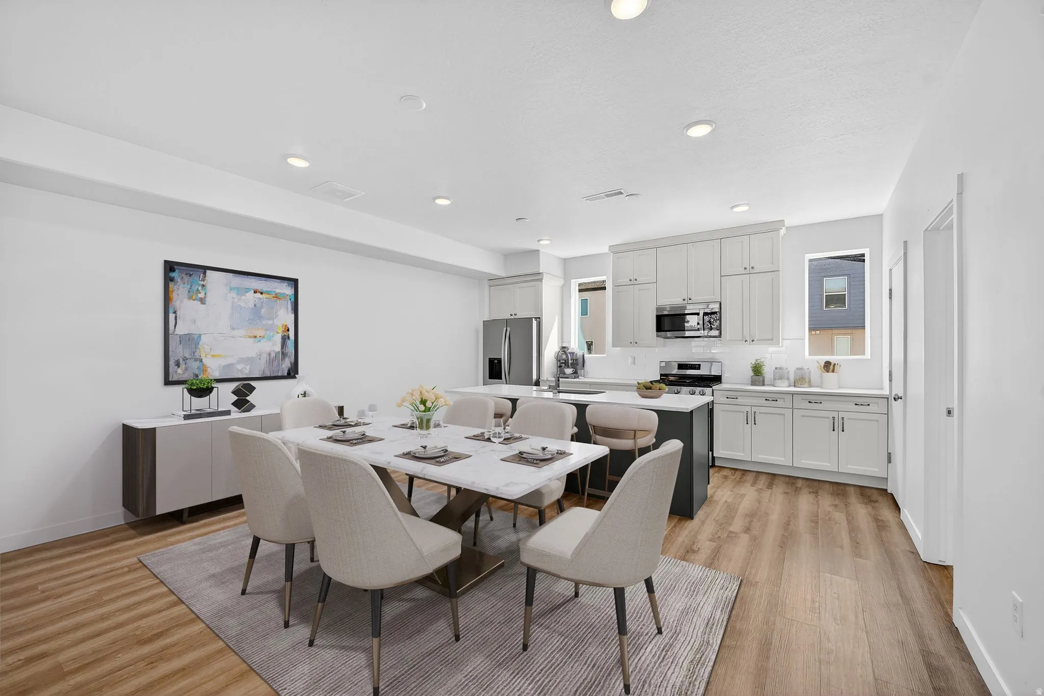 Dining area featuring light wood finished floors and recessed lighting
