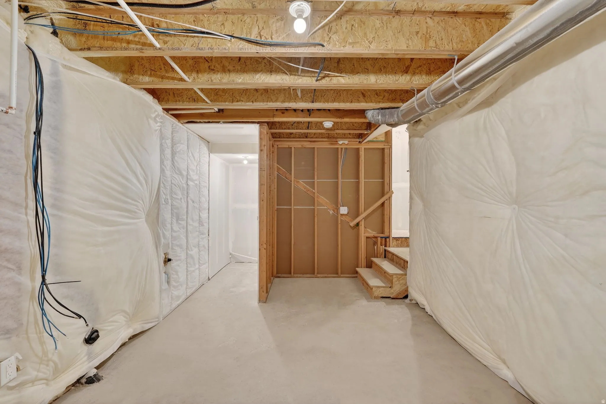 Unfinished basement featuring stairs