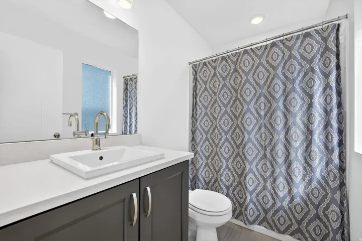 Full bathroom featuring vanity, a shower with curtain, and recessed lighting