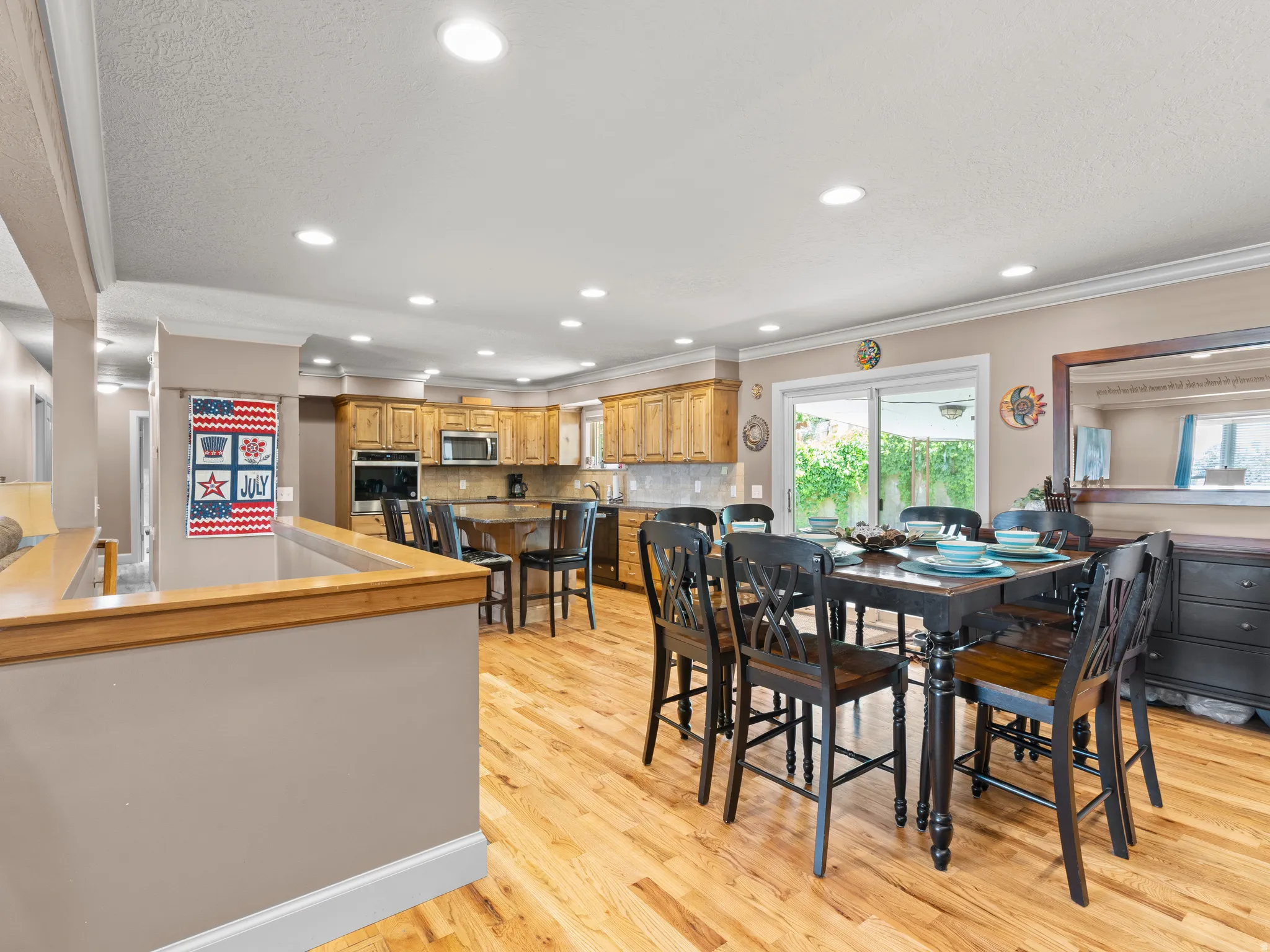 Dining room featuring crown molding, light wood-type flooring, and recessed lighting