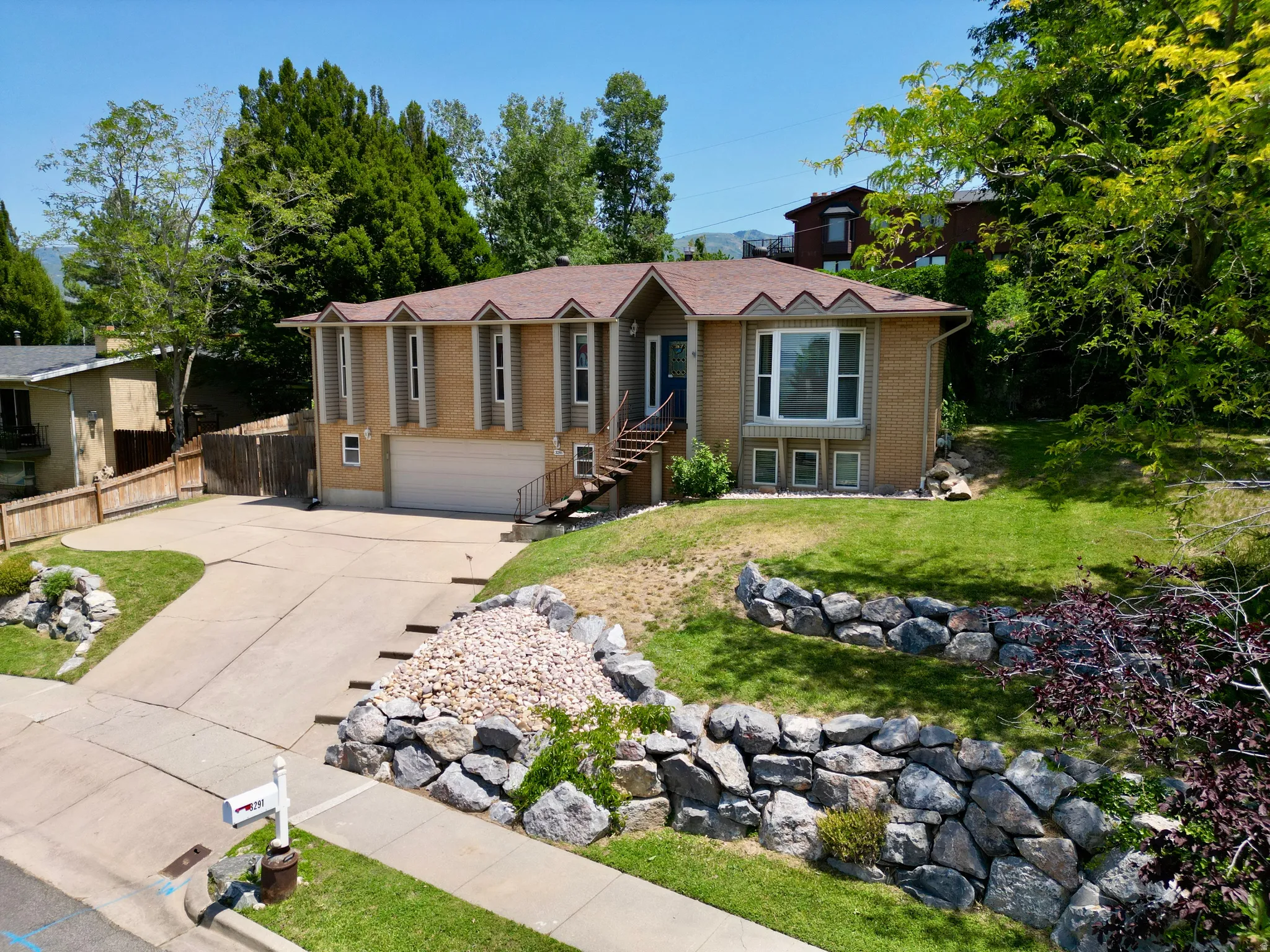 Single story home with concrete driveway, brick siding, and a garage
