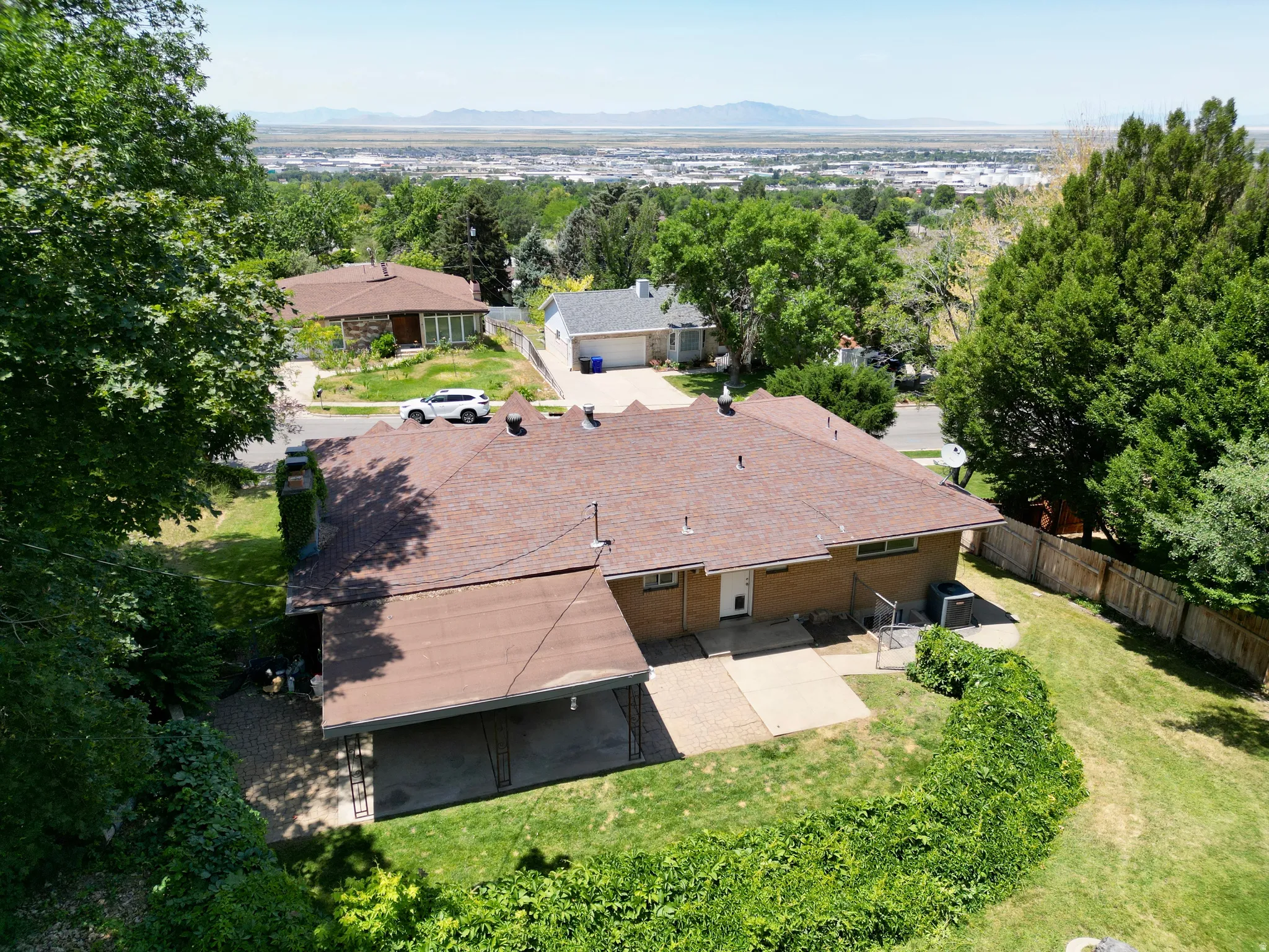 Bird's eye view of a mountain backdrop and a tree filled landscape