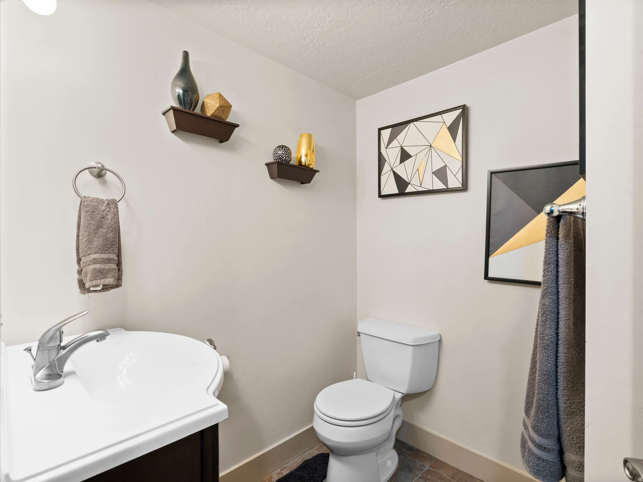Bathroom with a textured ceiling and vanity