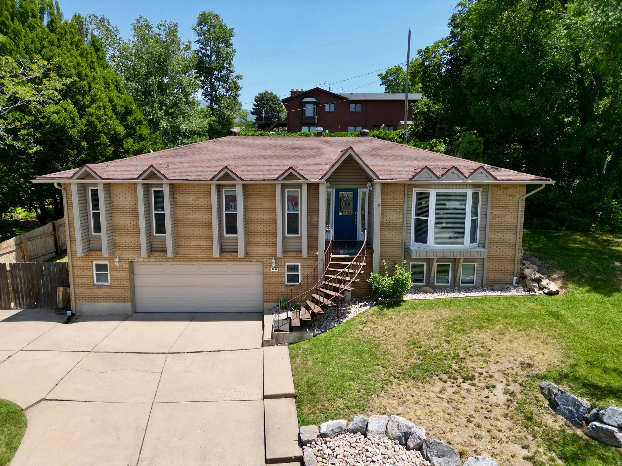 Ranch-style house with concrete driveway, a garage, and brick siding
