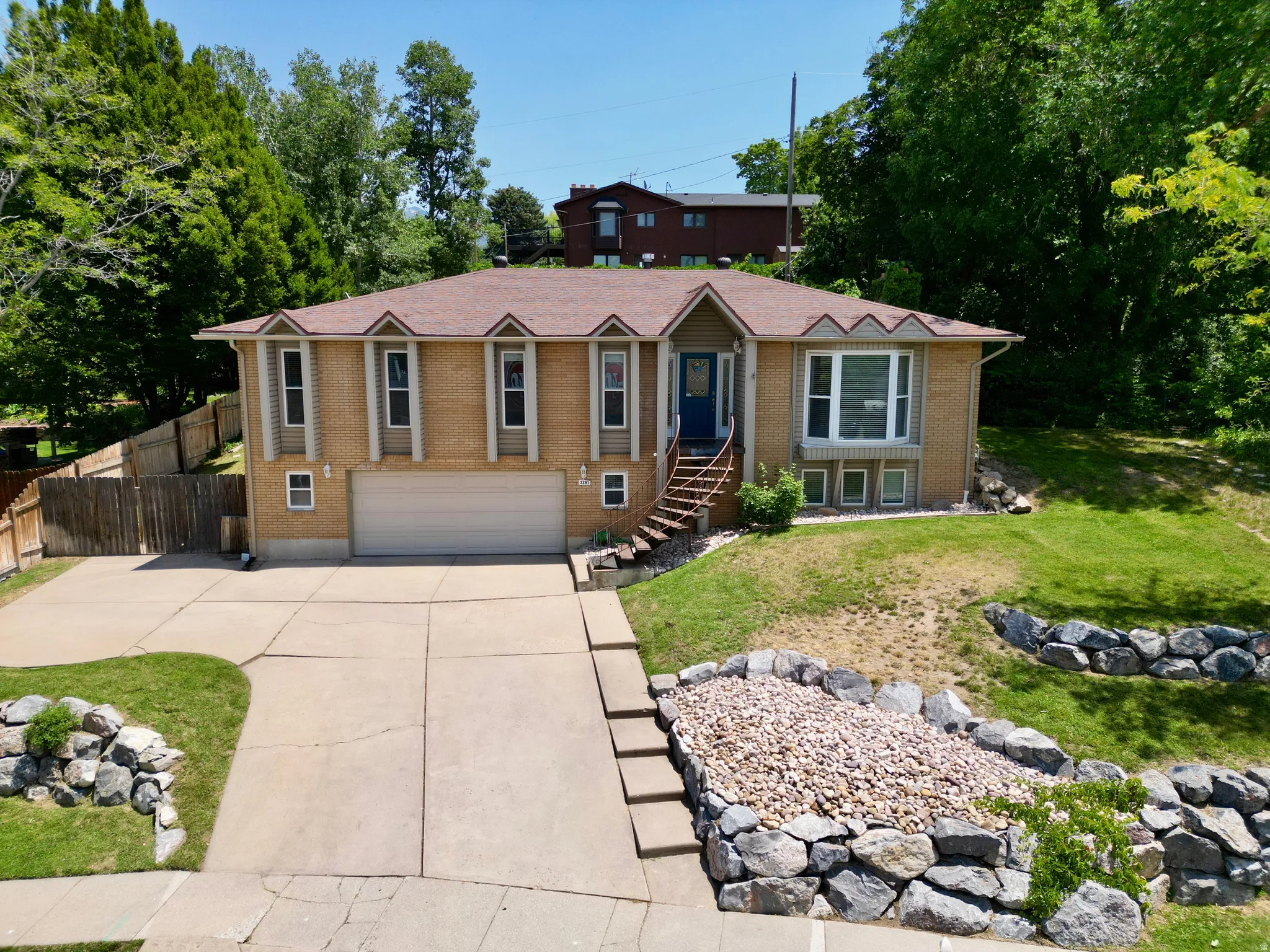 View of front facade with brick siding, an attached garage, and concrete driveway