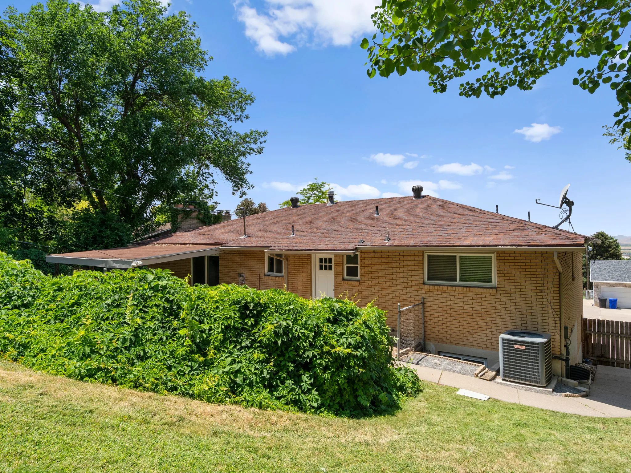 Back of house featuring brick siding