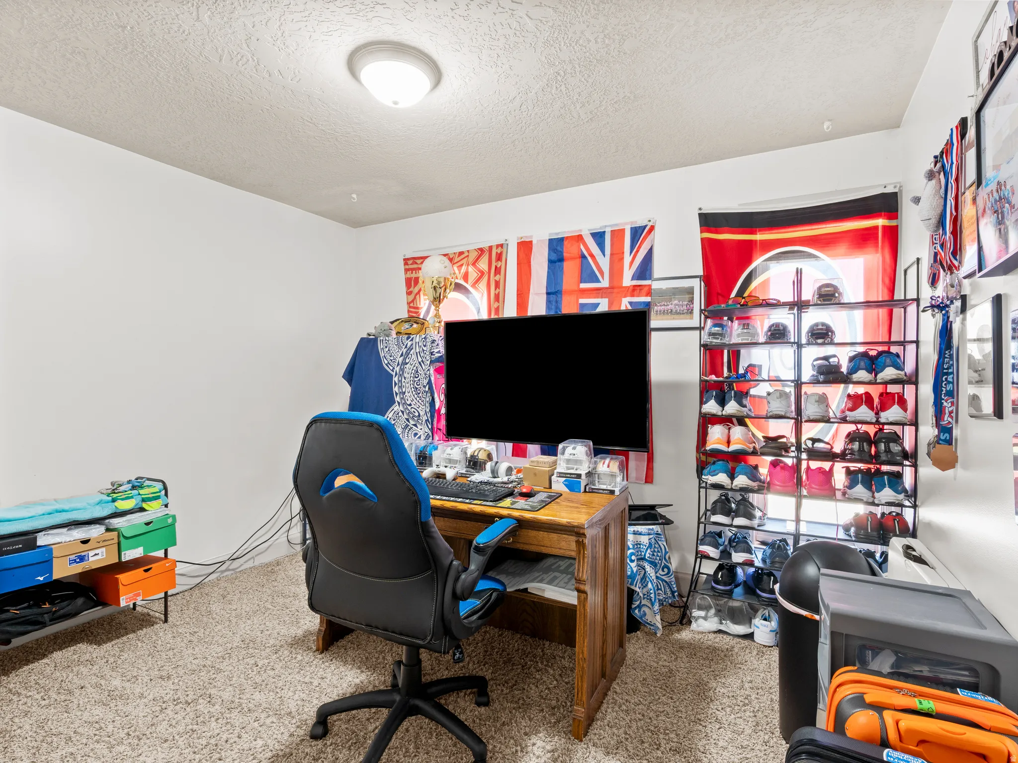 Office featuring light colored carpet and a textured ceiling