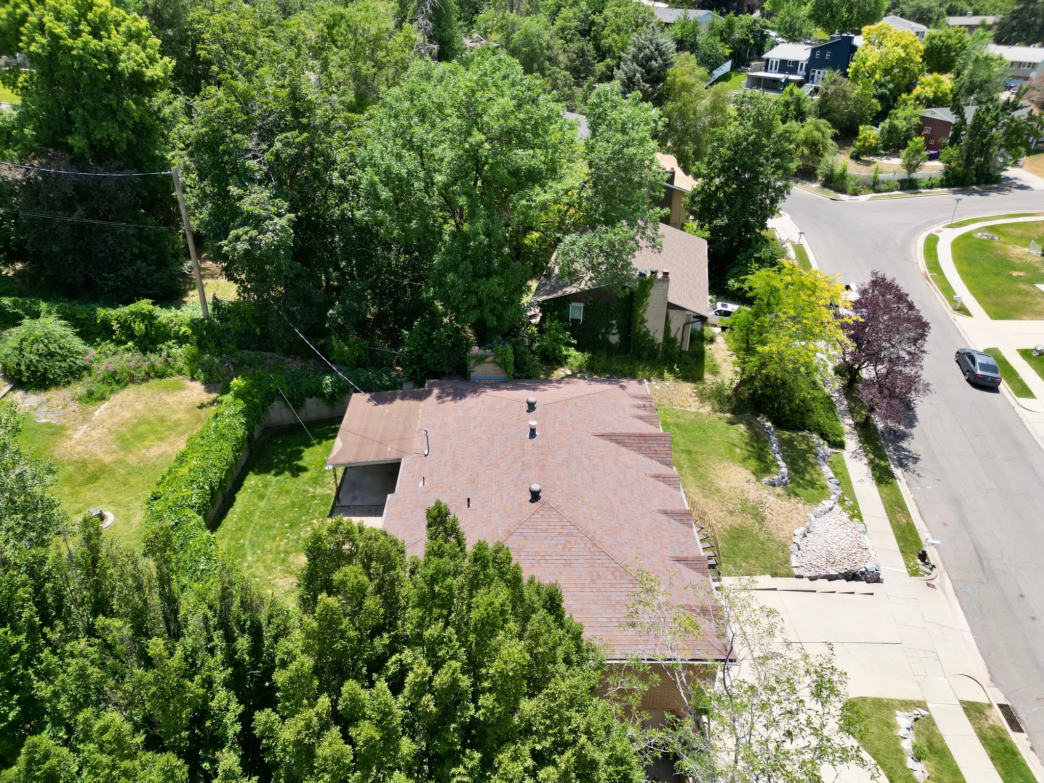 View from above of property featuring a tree filled landscape