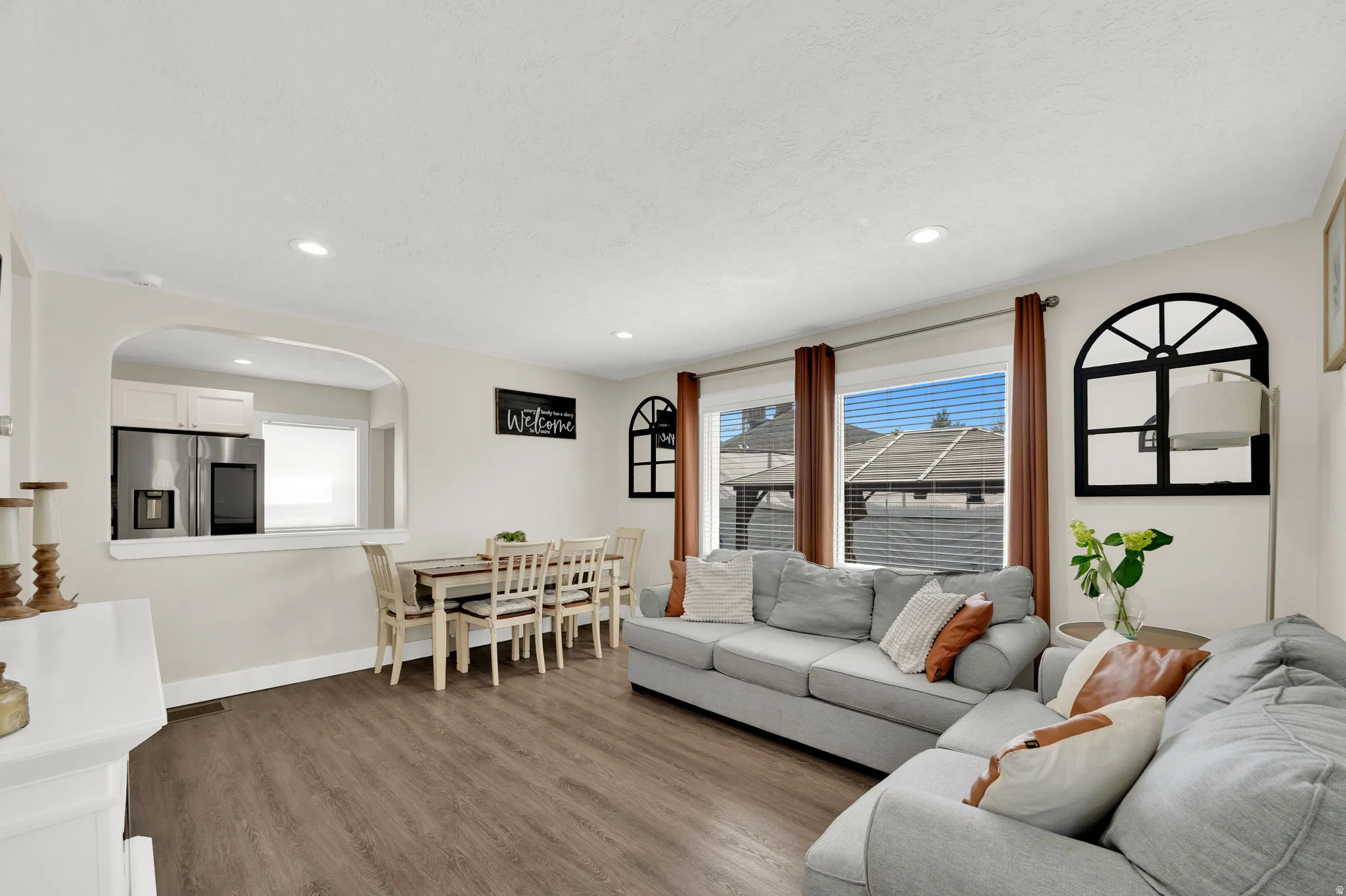 Living area featuring wood finished floors and recessed lighting