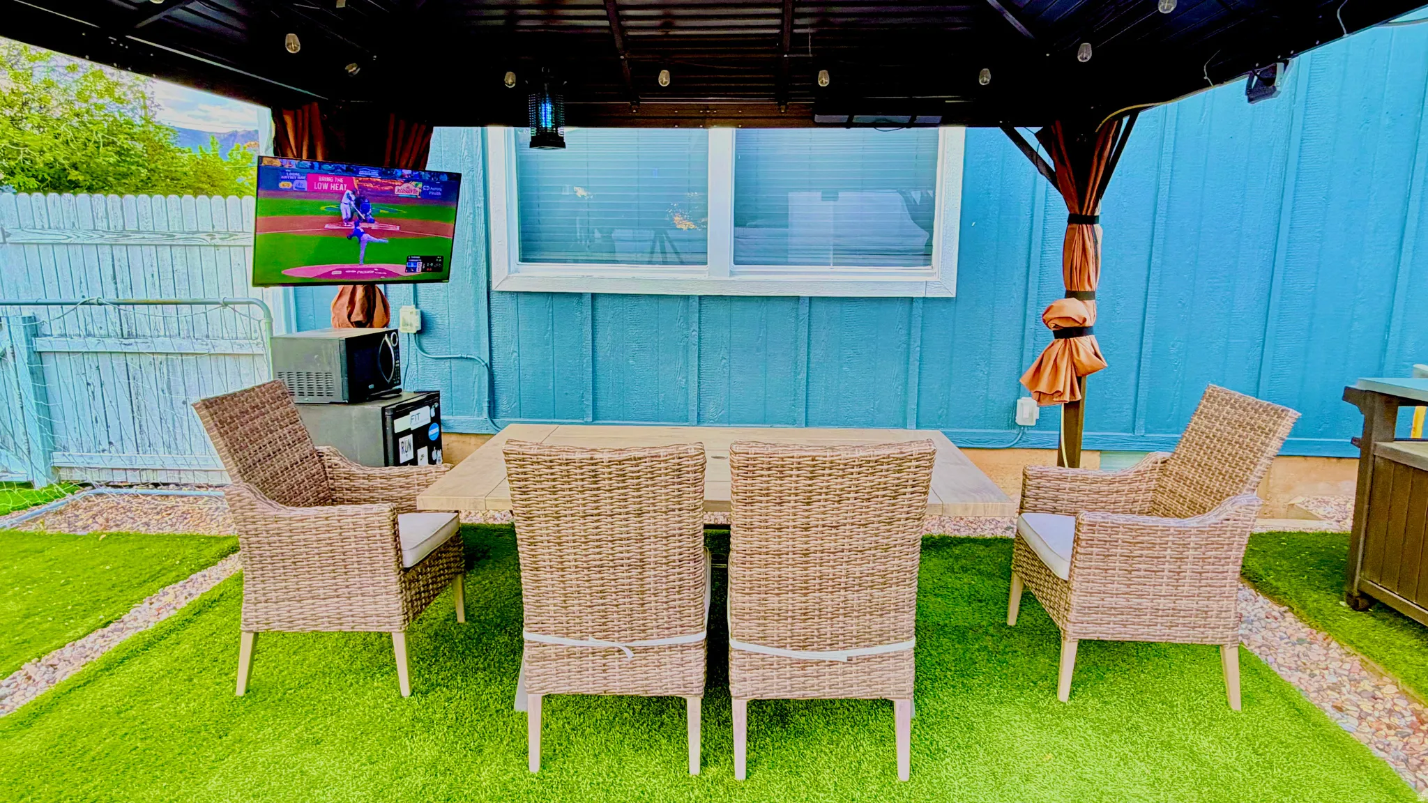 Outdoor covered patio featuring a mounted screen, recessed lighting, and a durable metal frame