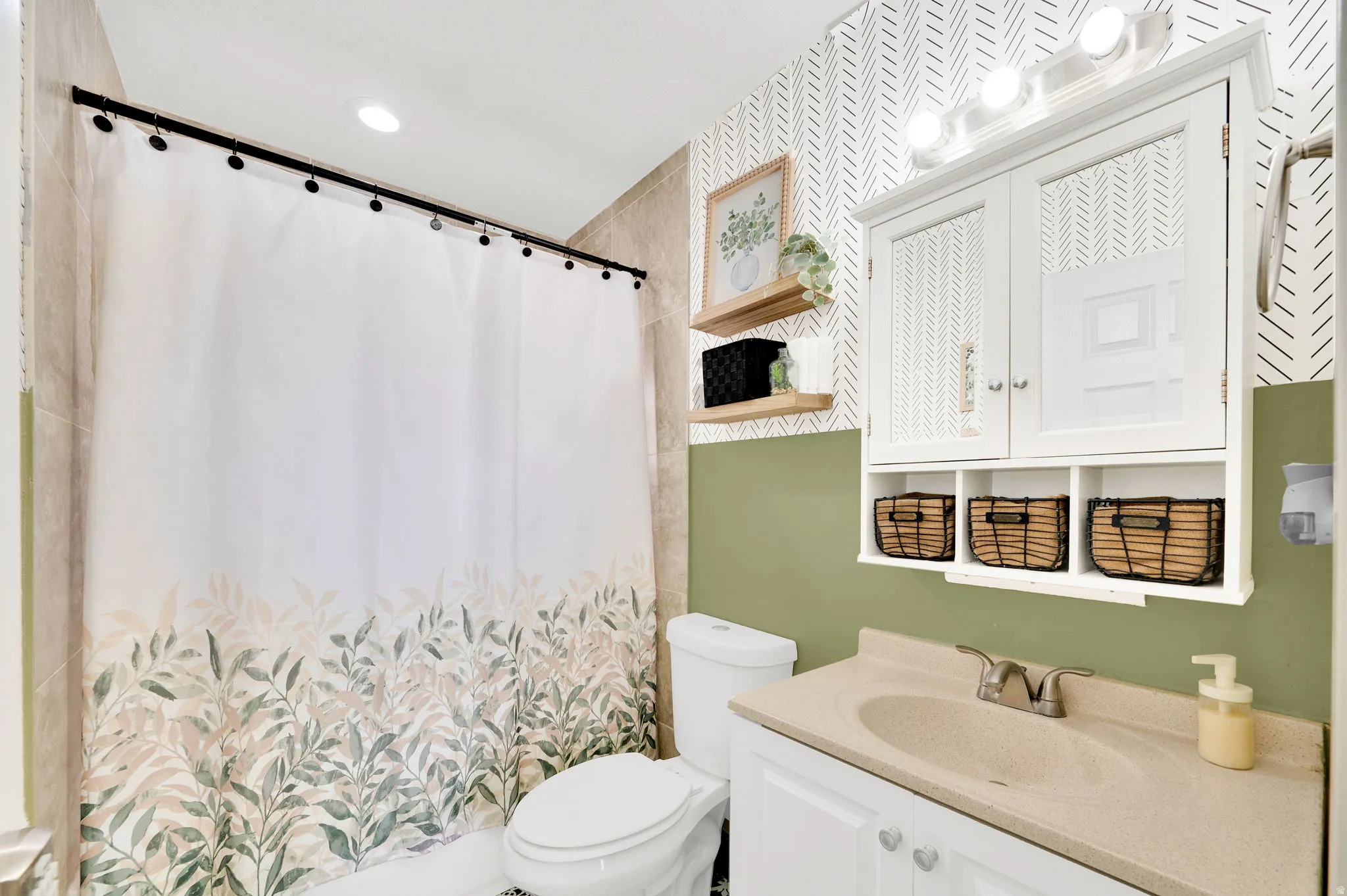 Bathroom with vanity and curtained shower