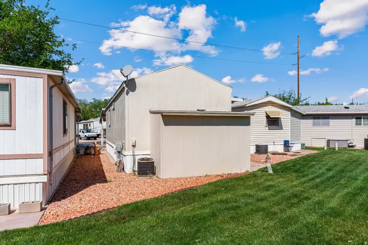 Rear view of house featuring attached storage shed.