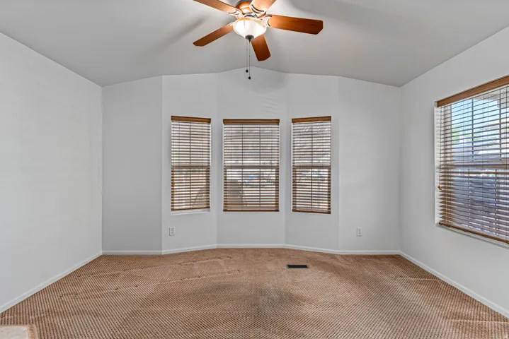 Living Room featuring carpet flooring, a ceiling fan, and vaulted ceiling