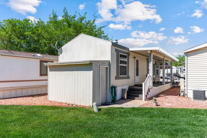 Back of property with a lawn