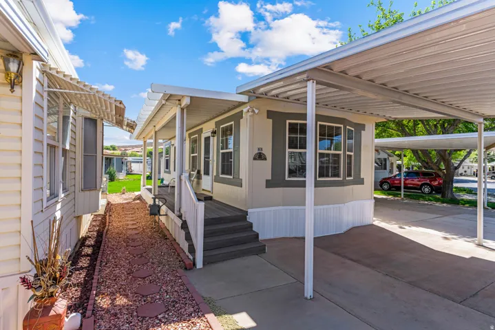 View of property exterior with an attached carport