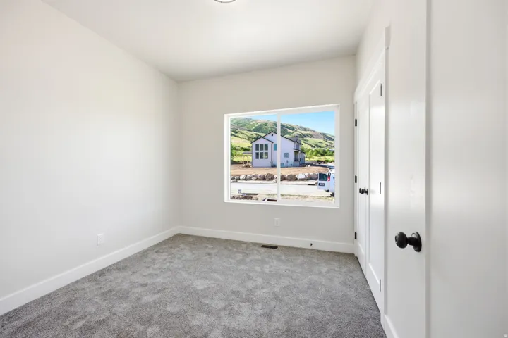 Neutral painted walls complemented by gray carpeting and white baseboards