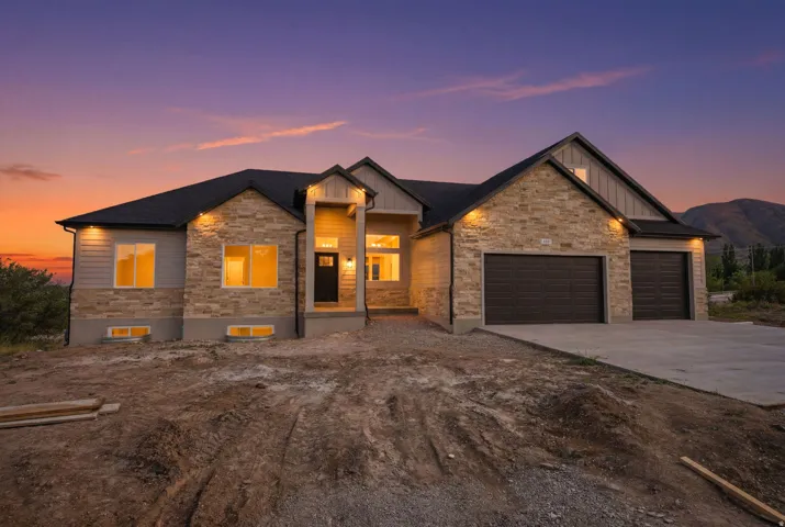 Contemporary single-story residence showcasing a stone and siding facade