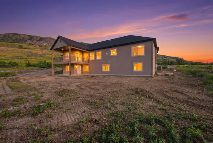 Contemporary two-story residence featuring a gray exterior finish and a dark shingle roof