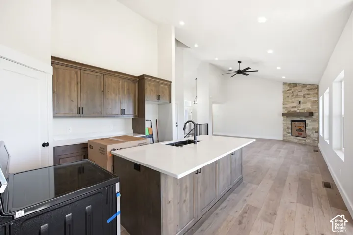 Open-concept living space with vaulted ceilings, recessed lighting, and wood-finish flooring