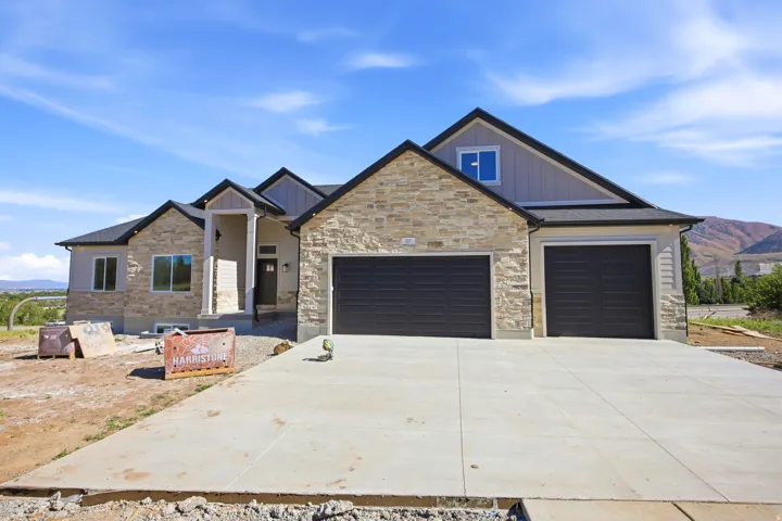 Stone and siding exterior with dark trim accents