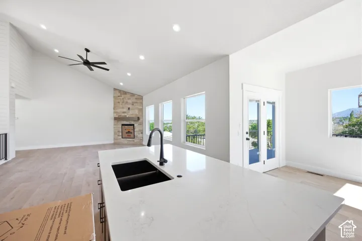 Kitchen island with a black undermount sink and matte black faucet, featuring a light-toned countertop