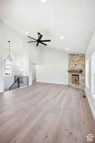 Expansive living area featuring vaulted ceilings, recessed lighting, and wood-finish flooring