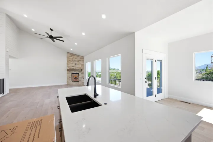 Kitchen island with a black undermount sink and matte black faucet, featuring a light-toned countertop