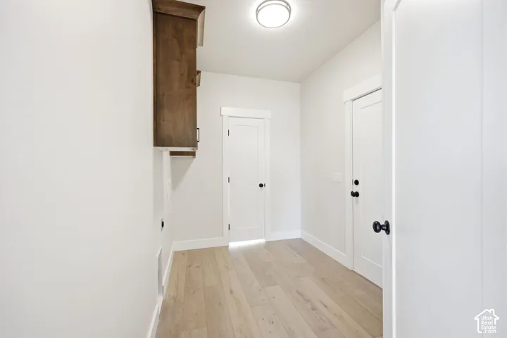 Hallway with wood-finish flooring and white baseboards