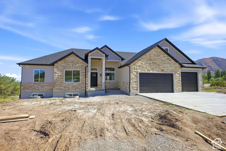 Modern farmhouse exterior featuring a stone and siding facade
