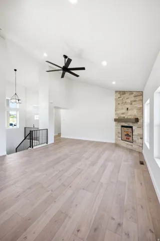 Expansive living area featuring vaulted ceilings, recessed lighting, and wood-finish flooring
