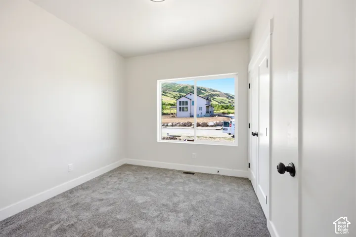 Neutral painted walls complemented by gray carpeting and white baseboards