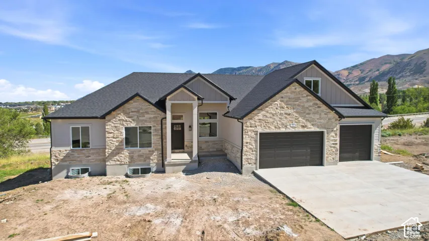 Modern ranch-style home featuring stone veneer and stucco siding