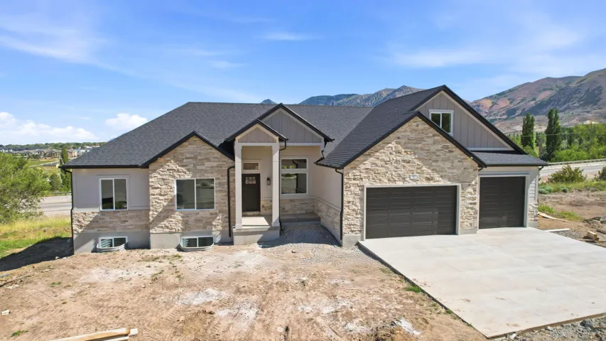 Modern ranch-style home featuring stone veneer and stucco siding
