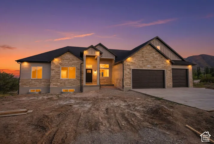 Contemporary single-story residence showcasing a stone and siding facade