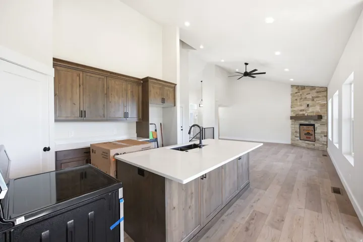 Open-concept living space with vaulted ceilings, recessed lighting, and wood-finish flooring