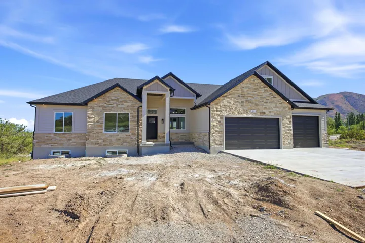 Modern farmhouse exterior featuring a stone and siding facade