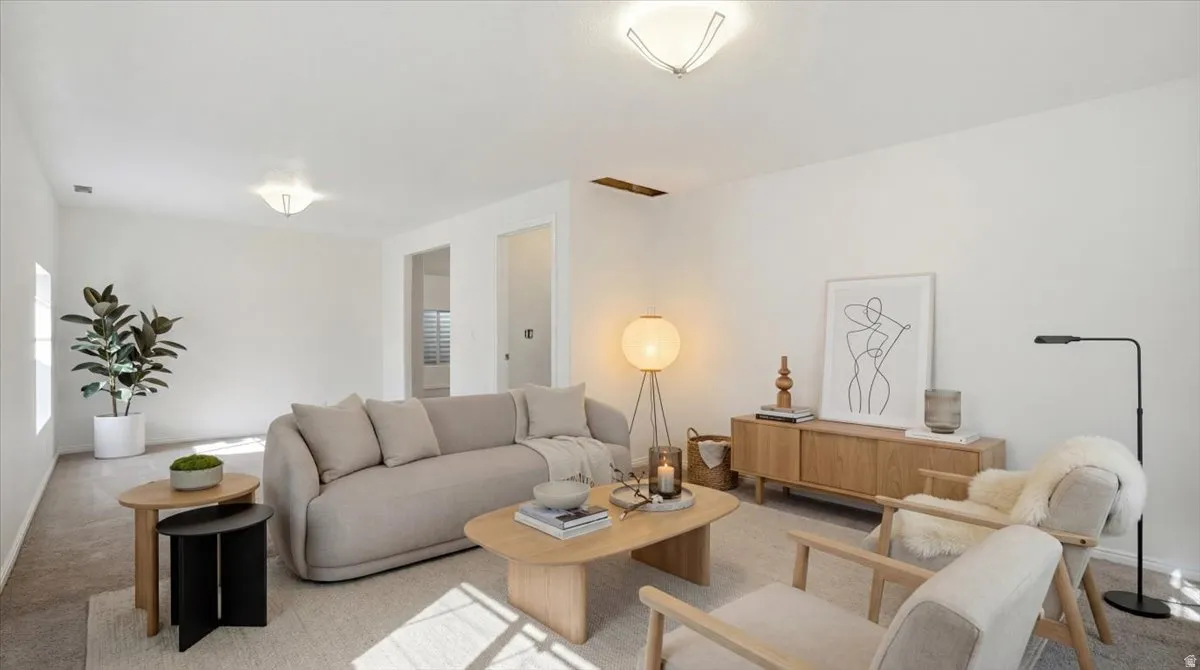 Carpeted living area featuring baseboards
