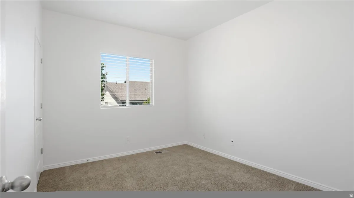 Neutral-toned carpeting and white baseboards
