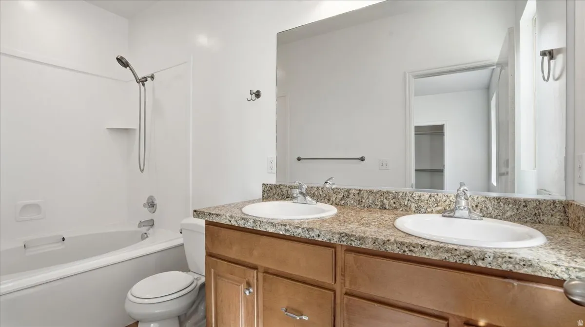 Bathroom with double vanity and tub / shower combination