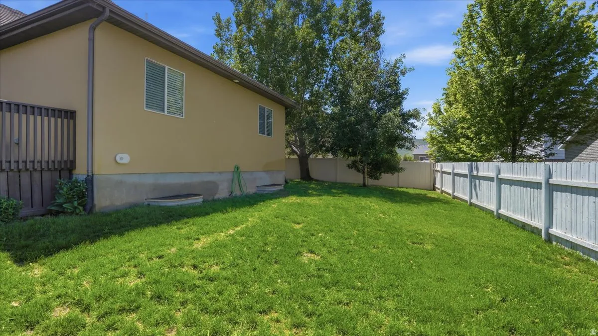Expansive green lawn with a perimeter fence