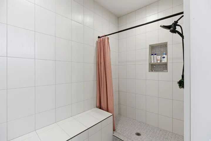 Full bathroom with a shower stall