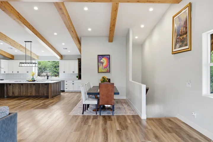 Dining area featuring recessed lighting, light wood-type flooring, and beam ceiling