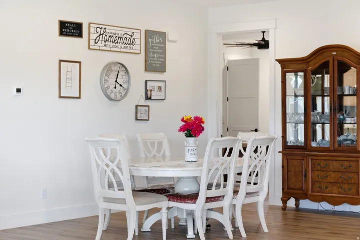 Dining area featuring wood finished floors and ceiling fan