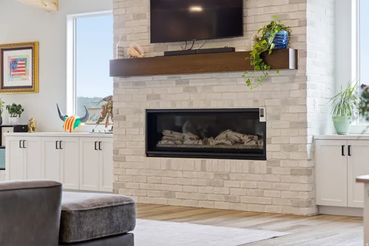 Living area with light wood finished floors and a brick fireplace