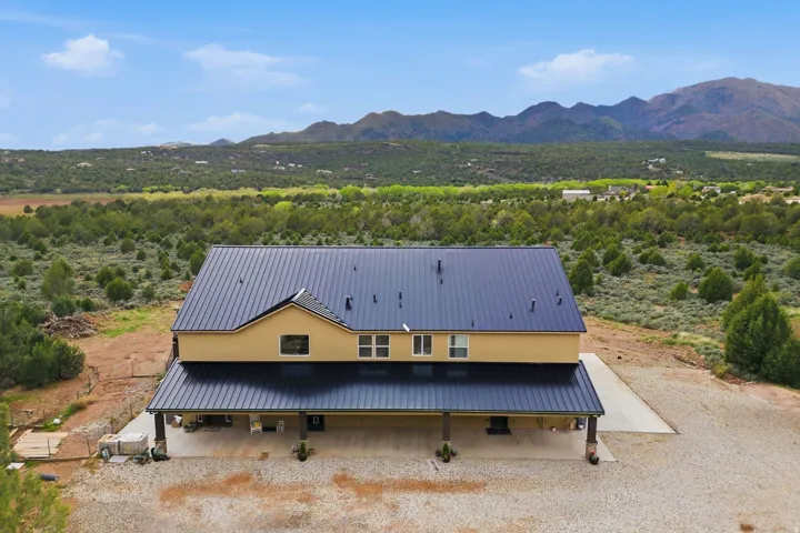 Aerial view of property and surrounding area featuring mountains