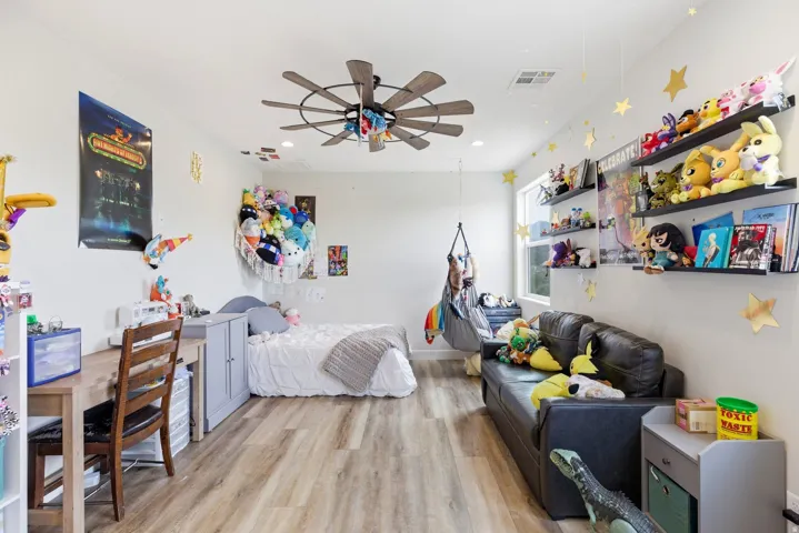 Bedroom with light wood-type flooring, ceiling fan, and recessed lighting
