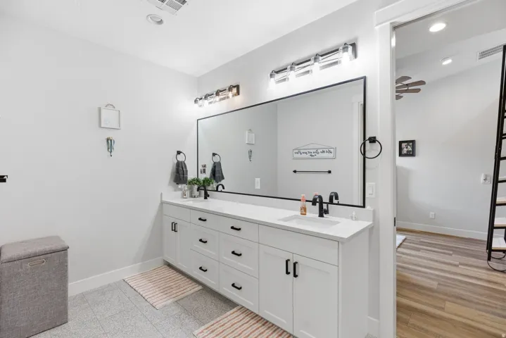 Full bath featuring double vanity, recessed lighting, and ceiling fan